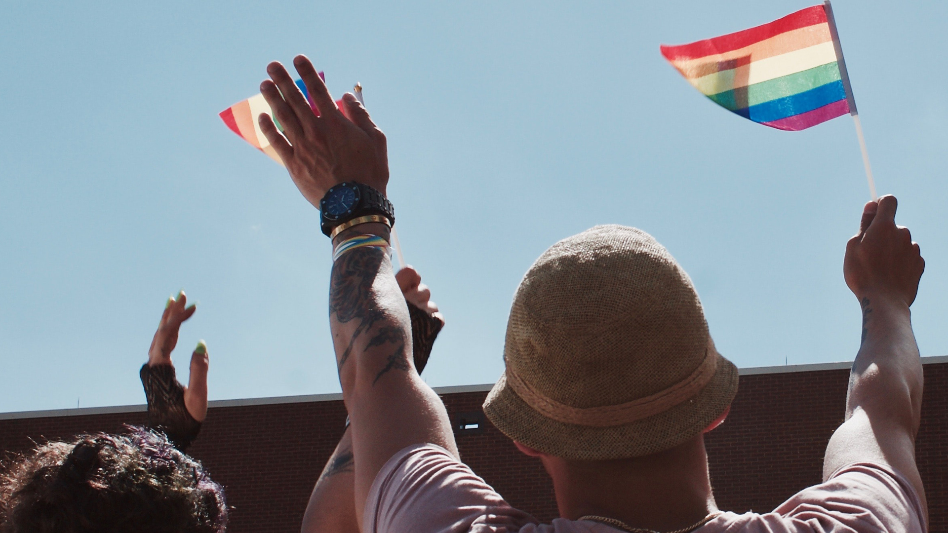 Protesters waving the rainbowflag